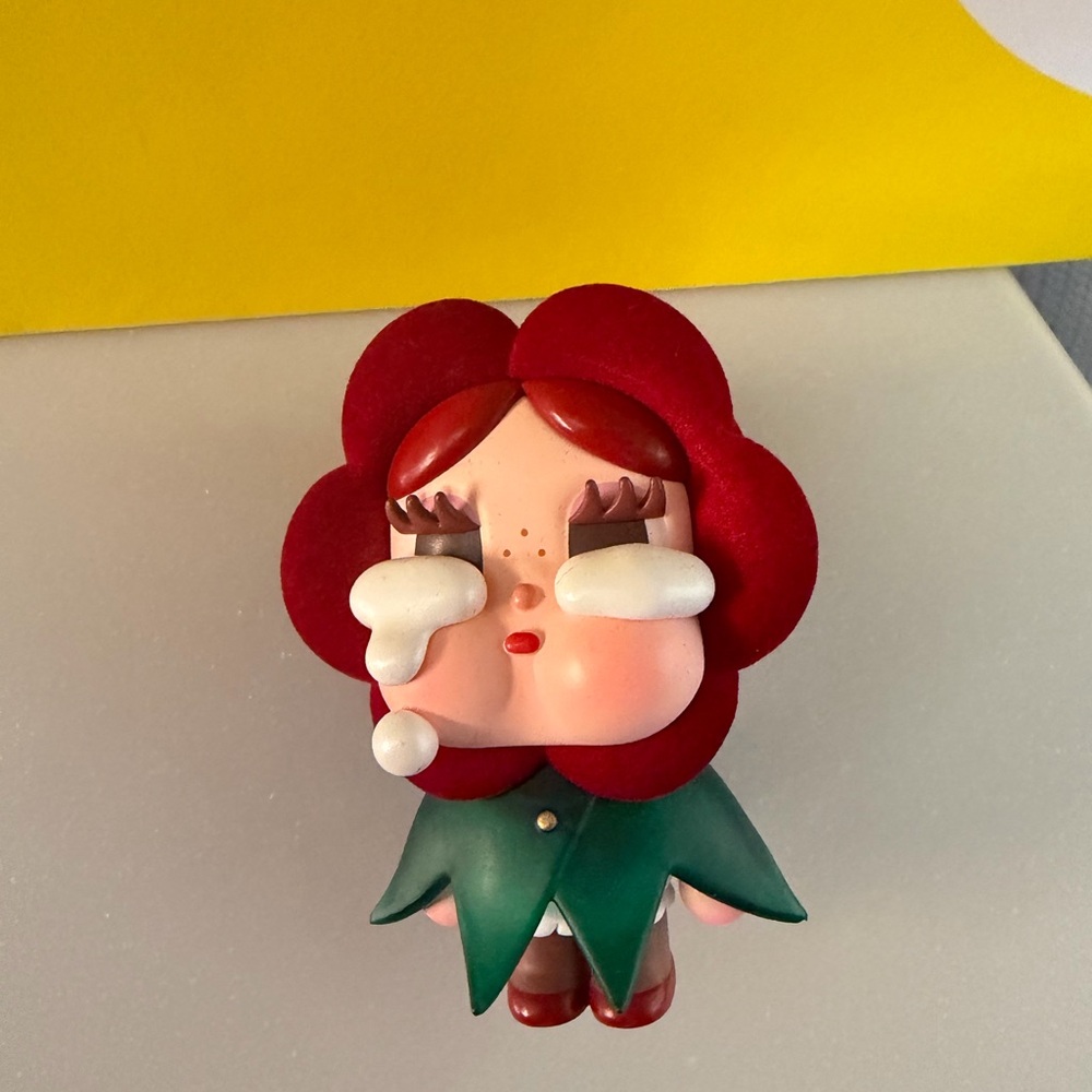 From PopMart is Whimsical Red Flower Figurine